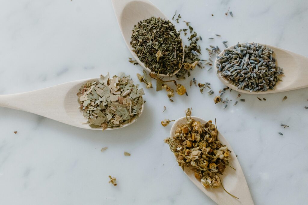 pexels-photo-6694164-6694164 Overhead view of dried plants on wooden spoons, representing herbal remedies and alternative medicine.